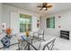 A cozy outdoor space featuring comfortable seating, a ceiling fan, and serene ambiance at 14184 Heritage Landing Blvd # 513, Punta Gorda, FL 33955