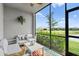 Relaxing screened lanai with comfortable seating and views of the pond and greenery at 14184 Heritage Landing Blvd # 513, Punta Gorda, FL 33955