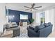 Cozy living room features a blue accent wall, modern furniture, and a large sliding door to the outside at 14184 Heritage Landing Blvd # 513, Punta Gorda, FL 33955