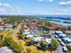 An aerial view showcasing a community that features a tennis court, pond with fountain, and manicured landscaping at 14519 Catalina Cir, Seminole, FL 33776