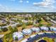 Enjoy this aerial view of the community with lush greenery, manicured landscaping, and serene water features at 14519 Catalina Cir, Seminole, FL 33776