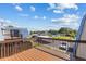 Balcony featuring view of community tennis courts, parking and townhome roofs at 14519 Catalina Cir, Seminole, FL 33776