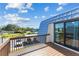 Balcony with a view of the community featuring a tennis court and covered parking at 14519 Catalina Cir, Seminole, FL 33776