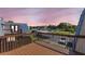 Balcony featuring view of community tennis courts, parking and townhome roofs at dusk at 14519 Catalina Cir, Seminole, FL 33776
