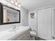Bathroom with modern vanity, sink, mirror, and a shower with a patterned curtain at 14519 Catalina Cir, Seminole, FL 33776