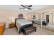 Bedroom featuring mirrored closet doors, ceiling fan and a large ottoman at 14519 Catalina Cir, Seminole, FL 33776