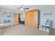 Bedroom featuring a Murphy bed, wall decor, a mirrored closet, and a ceiling fan at 14519 Catalina Cir, Seminole, FL 33776