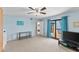 Spacious bedroom with light blue walls, a ceiling fan, and sliding glass doors leading to a balcony at 14519 Catalina Cir, Seminole, FL 33776