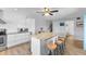 Kitchen with granite countertops, white cabinets and stainless steel appliances, including an island and seating at 14519 Catalina Cir, Seminole, FL 33776