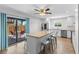 Open kitchen featuring granite island, stainless steel appliances and sliding glass door to the patio with outdoor seating at 14519 Catalina Cir, Seminole, FL 33776