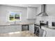 Modern kitchen featuring white cabinets, granite counters, stainless appliances, and a subway tile backsplash at 14519 Catalina Cir, Seminole, FL 33776