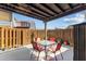 Relaxing outdoor patio with table, chairs, privacy fence, and convenient access to the interior at 14519 Catalina Cir, Seminole, FL 33776