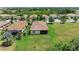 Aerial view of the home showcasing the tile roof, screened lanai, and expansive grassy backyard at 157 Wandering Wetlands Cir, Bradenton, FL 34212