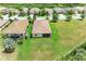 Aerial view of the home showcasing the tile roof, screened lanai, and expansive grassy backyard at 157 Wandering Wetlands Cir, Bradenton, FL 34212