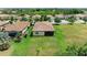 Aerial view of the home showcasing the tile roof, screened lanai, and expansive grassy backyard at 157 Wandering Wetlands Cir, Bradenton, FL 34212