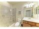 Bathroom featuring glass enclosed shower, single sink vanity, and neutral tiling at 157 Wandering Wetlands Cir, Bradenton, FL 34212