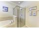 Bathroom featuring a glass-enclosed shower and separate soaking tub at 157 Wandering Wetlands Cir, Bradenton, FL 34212