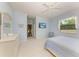 Bedroom features a television, dresser, and lots of natural light at 157 Wandering Wetlands Cir, Bradenton, FL 34212