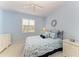 Light and airy bedroom with pale blue walls, white trim, and a charming coastal theme at 157 Wandering Wetlands Cir, Bradenton, FL 34212