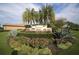Elegant community entrance sign surrounded by lush landscaping and colorful flowers at 157 Wandering Wetlands Cir, Bradenton, FL 34212