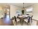Cozy dining area featuring a wooden table, seating for six, and a large window for natural light at 157 Wandering Wetlands Cir, Bradenton, FL 34212