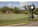Scenic driving range view with palm trees, manicured lawn, and picturesque surroundings at 157 Wandering Wetlands Cir, Bradenton, FL 34212