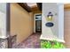 Welcoming front entryway with decorative door, exterior lighting, and brick pathway to number 157 at 157 Wandering Wetlands Cir, Bradenton, FL 34212