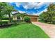 Charming home with lush landscaping, brick driveway, and a two-car garage, perfect for any Gathering at 157 Wandering Wetlands Cir, Bradenton, FL 34212