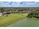 Scenic golf course and lake view, showcasing the clubhouse and beautiful landscaping within the community at 157 Wandering Wetlands Cir, Bradenton, FL 34212