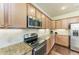 Kitchen features granite countertops, stainless appliances, and hardwood floors at 157 Wandering Wetlands Cir, Bradenton, FL 34212