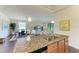 Open-concept kitchen featuring granite countertops overlooking the dining and living areas at 157 Wandering Wetlands Cir, Bradenton, FL 34212