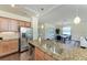 Kitchen with granite countertops overlooks a dining area and living room at 157 Wandering Wetlands Cir, Bradenton, FL 34212