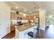 Well-lit kitchen features a granite countertop island with seating and stainless steel appliances at 157 Wandering Wetlands Cir, Bradenton, FL 34212