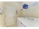 Laundry room featuring a washer, dryer, wire shelving and tile flooring at 157 Wandering Wetlands Cir, Bradenton, FL 34212