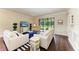 Bright living room with a coastal theme, comfortable seating, and a view to the outdoor living space at 157 Wandering Wetlands Cir, Bradenton, FL 34212
