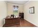 Traditional style office with hardwood floors, a large wooden desk, and natural light from the window at 157 Wandering Wetlands Cir, Bradenton, FL 34212