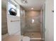 Bathroom showcases a glass shower, neutral tiled walls, and natural light from a window at 1703 N Tamiami Trl # 511, Sarasota, FL 34234