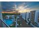 A nice view of the condos, parking, and community pool at sunset from the balcony at 1703 N Tamiami Trl # 511, Sarasota, FL 34234