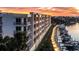 Modern condo building with private balconies overlooking a boat dock and waterfront at sunset at 1703 N Tamiami Trl # 511, Sarasota, FL 34234