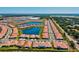 Expansive aerial view of the neighborhood showcasing rooftops, lakes, and the surrounding community at 17576 Holly Well Ave, Wimauma, FL 33598