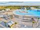 Aerial view of stunning community pool with white sand beach, splash pad and resort style amenities at 17576 Holly Well Ave, Wimauma, FL 33598