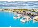 Aerial shot of a serene community lagoon area with beach, floating lounge areas, and relaxing cabanas at 17576 Holly Well Ave, Wimauma, FL 33598