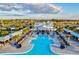 Aerial view of a luxurious community pool featuring lounge areas and cabanas, perfect for relaxation at 17576 Holly Well Ave, Wimauma, FL 33598