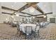 Large event space with round tables, elegant chairs, and stylish decor for hosting gatherings at 17576 Holly Well Ave, Wimauma, FL 33598