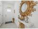 Inviting foyer features a welcome sign, decorative mirror, and stylish accents at 17576 Holly Well Ave, Wimauma, FL 33598