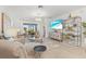 Comfortable living room with stylish furniture, a large television, and natural light at 17576 Holly Well Ave, Wimauma, FL 33598