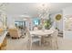 Open-concept living space with elegant decor, a dining area, and seamless access to outdoor living at 17576 Holly Well Ave, Wimauma, FL 33598