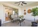 Relaxing patio with comfortable seating, ceiling fan, and a view to the outdoor landscape at 17576 Holly Well Ave, Wimauma, FL 33598