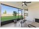 Relaxing screened lanai with a comfortable seating area, ceiling fan, and expansive backyard views at 17576 Holly Well Ave, Wimauma, FL 33598