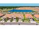 Aerial view of the community featuring well-manicured landscaping, a pond, and surrounding amenities at 17578 Holly Well Ave, Wimauma, FL 33598